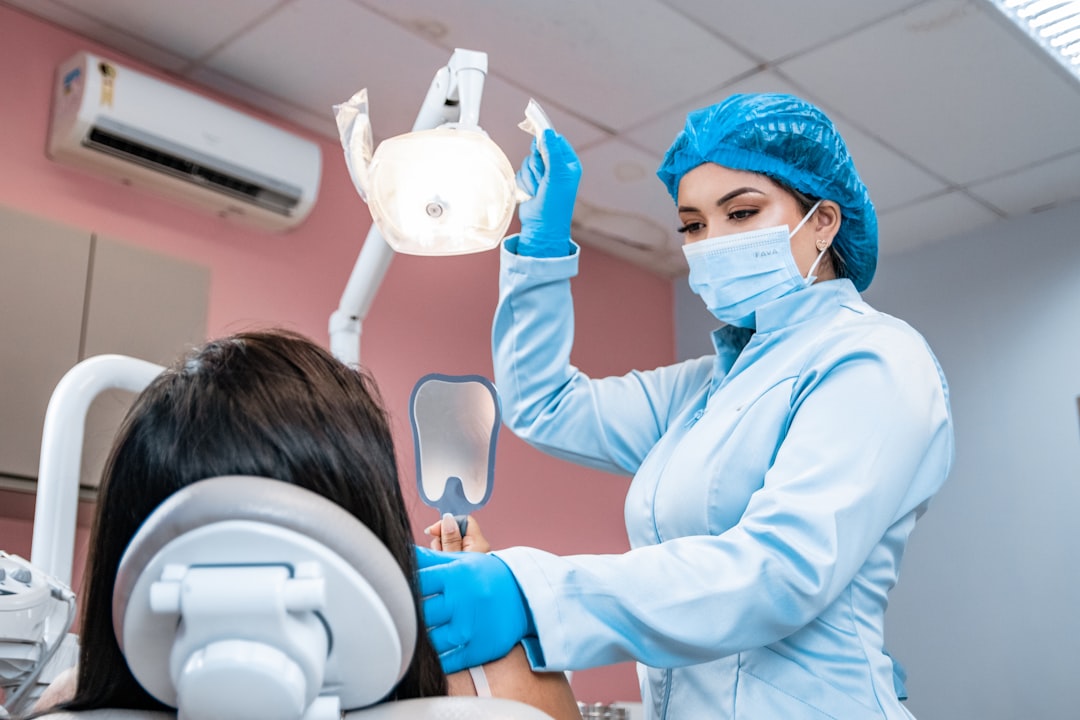 Dentist checking a patient's teeth during an exam