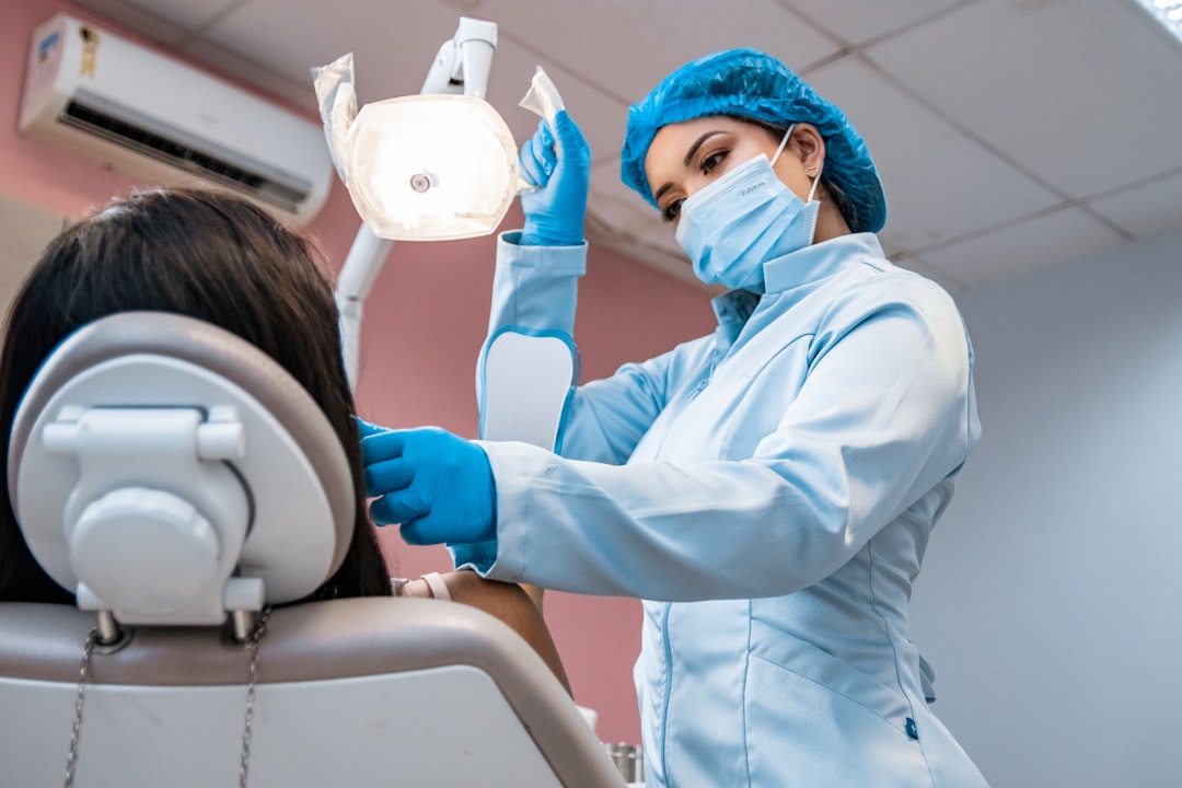 Dentist examining a patient's gums and teeth during a checkup