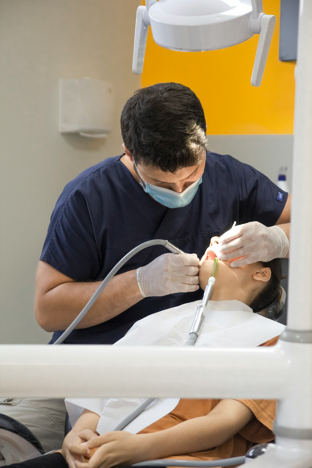 Dentist working closely with a patient during an exam